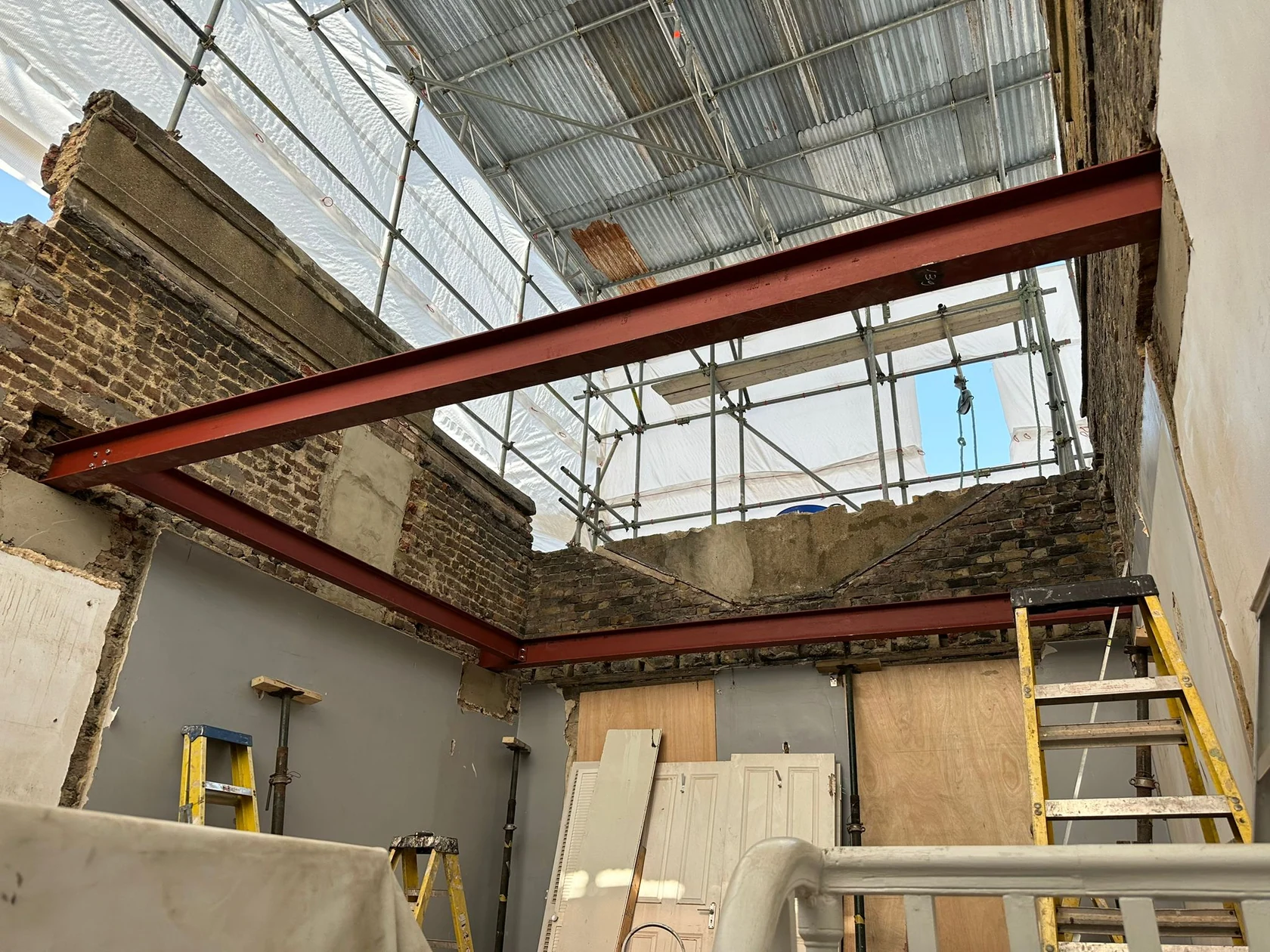 Faroe Road: Construction stage: steelwork and roof structure exposed.