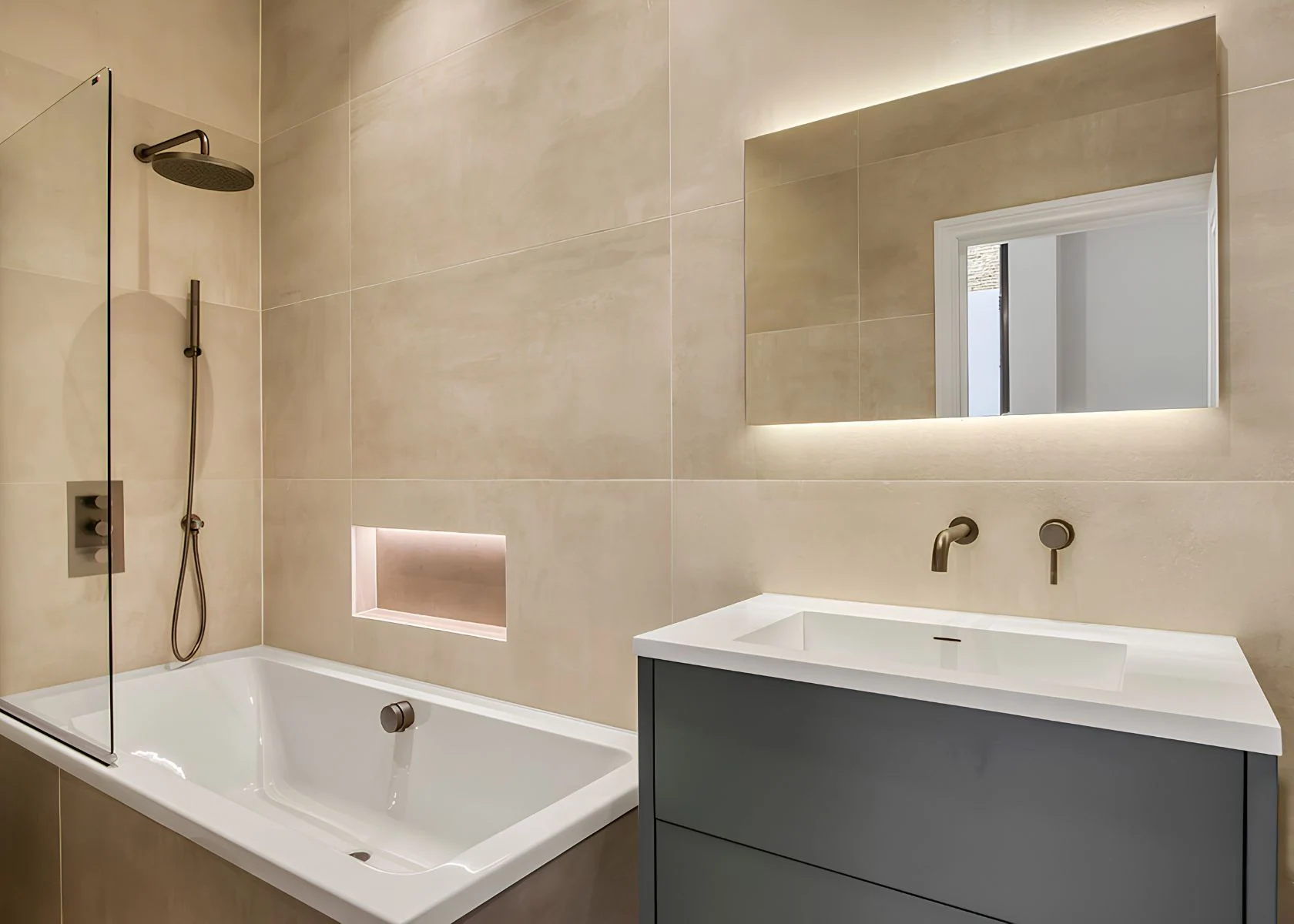 Fernhurst Road: The bathroom with recessed shelf and illuminated mirror.