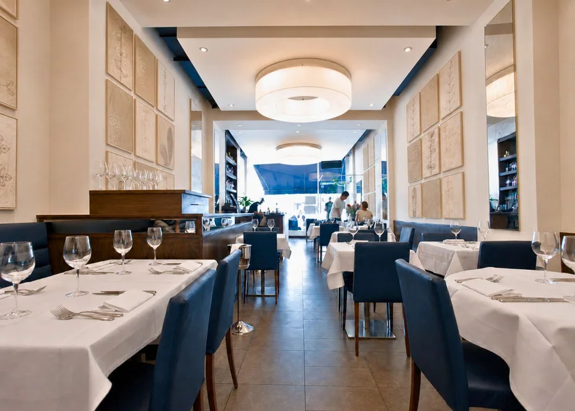 The dining room at Pimlico Road, showing ceiling lighting, wall panels and seating.