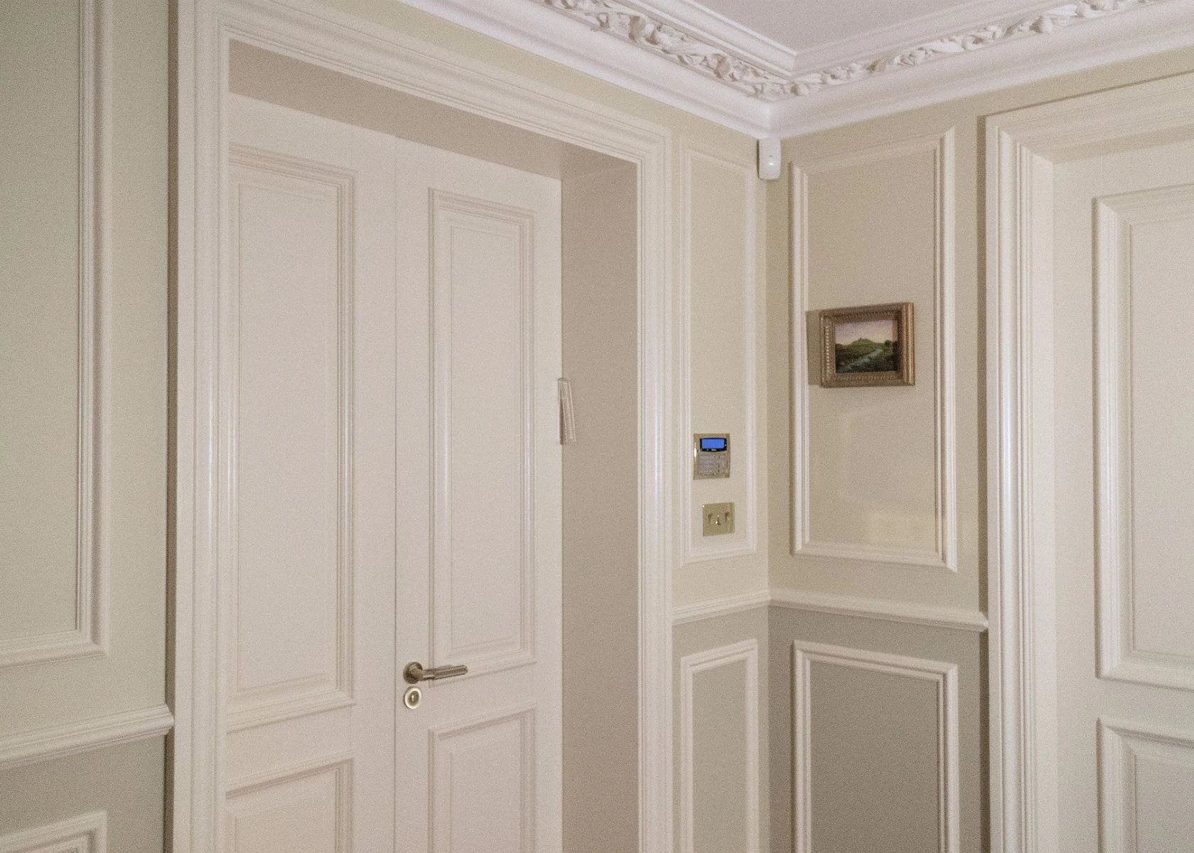 Queen Elizabeth: Panelled doors and the entrance-hall finishes.