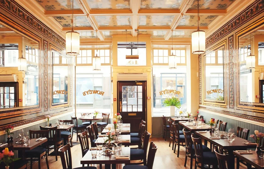 The main restaurant dining room at Rowley’s, showing the decorative ceiling and wall panels.